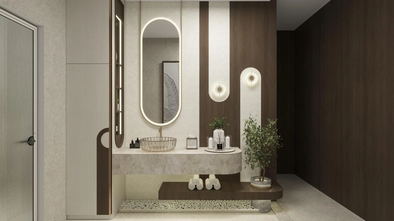 Bathroom vanity design with an illuminated oval mirror and warm stone