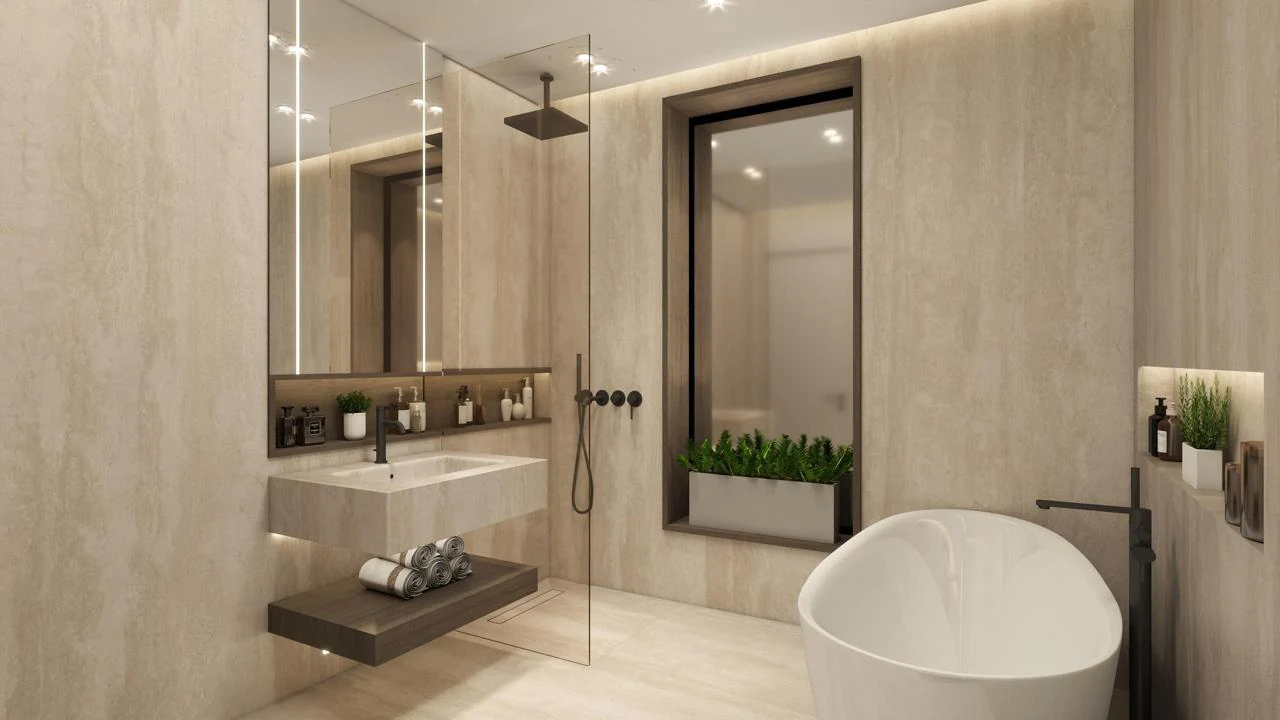 Bathroom design with a freestanding bath and lit stone vanity